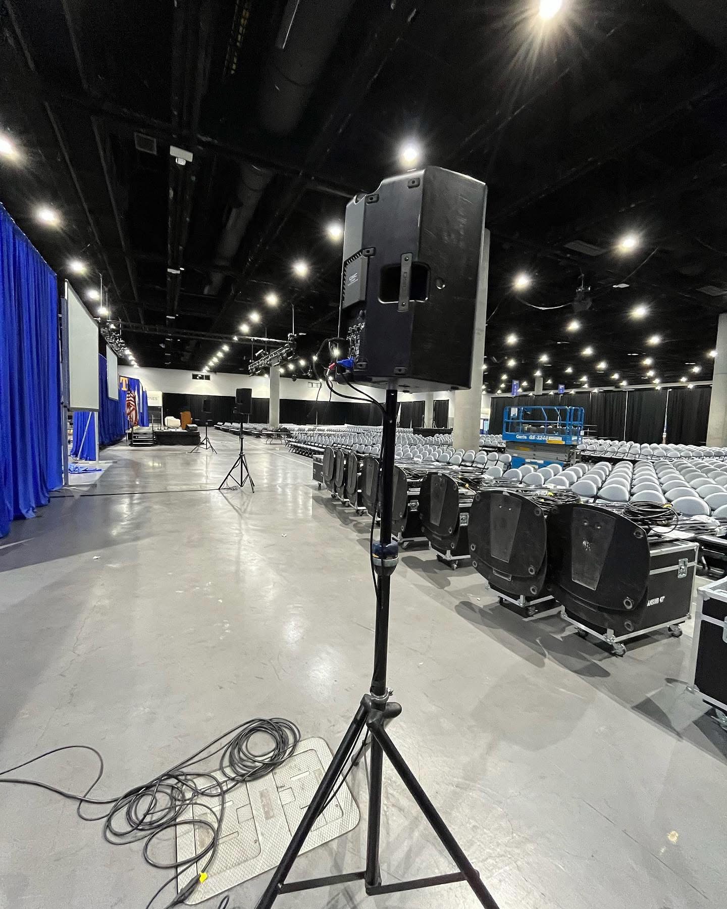 Speaker on stand at a large indoor venue