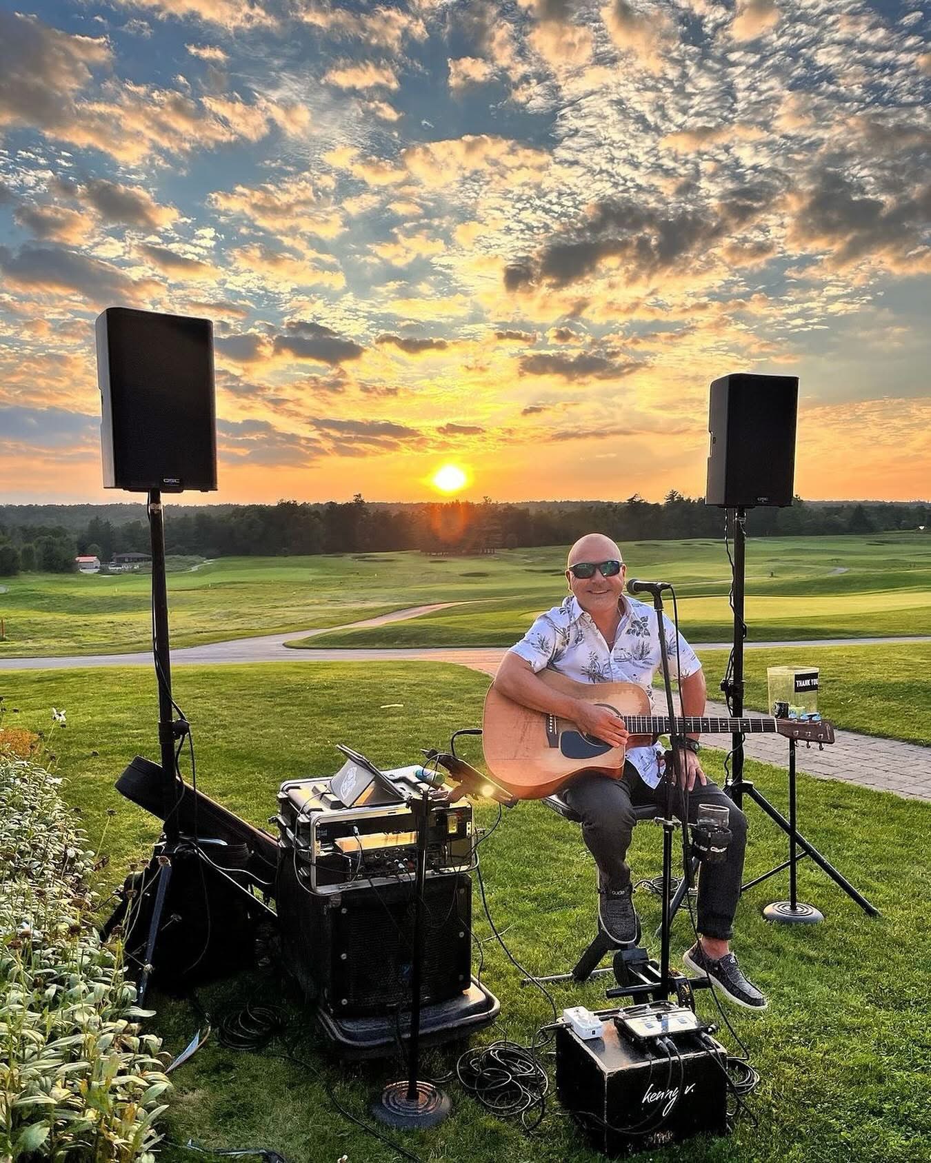 Live outdoor performance with speaker stands at sunset